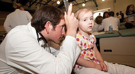 Audiology doctor with youth patient