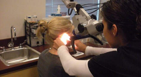 Audiology student performing hearing test.