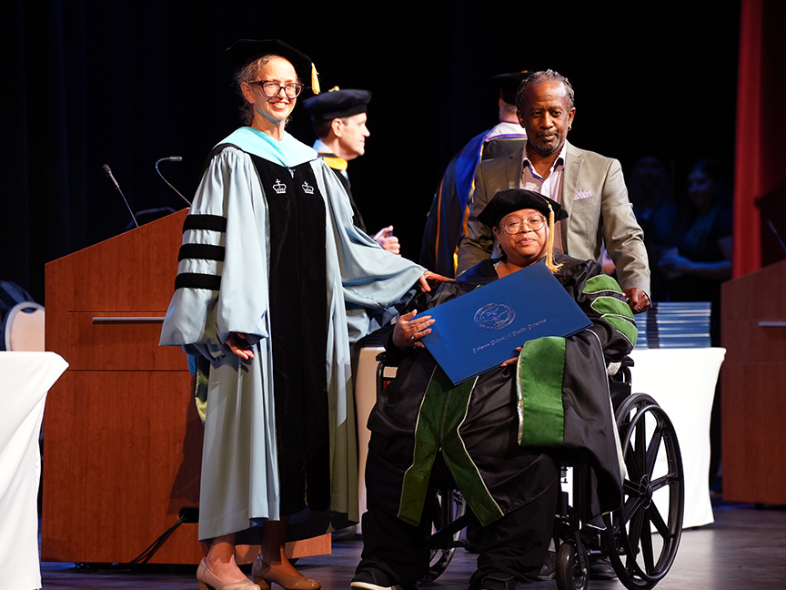 ATSU DMSc graduate receiving her diploma on stage during the commencement ceremony