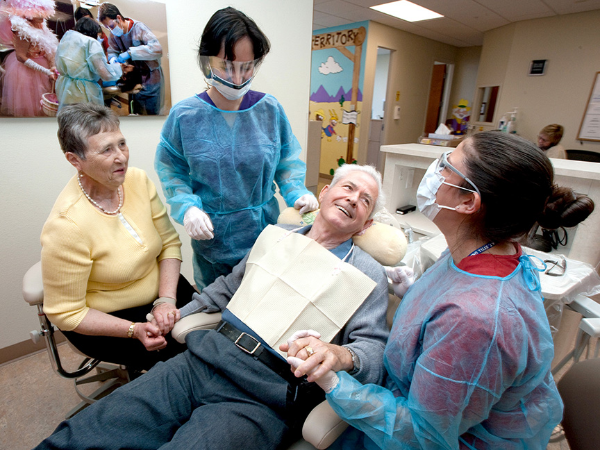 Dentists helping patient