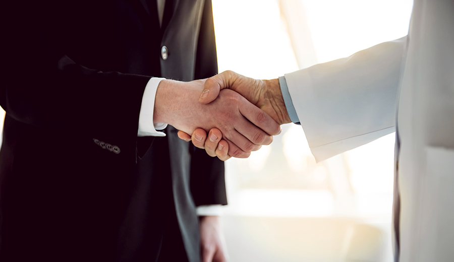 Business man and doctor shaking hands