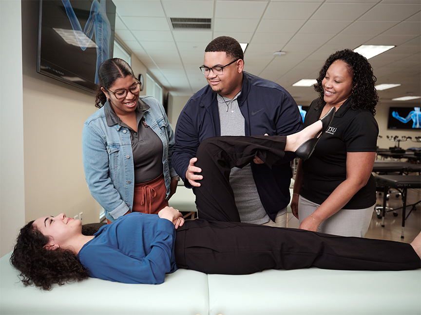 Healthcare student smiling at the camera in a healthcare setting, showcasing enthusiasm and professional development in the field.