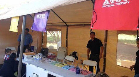 ATSU Physical Therapy Department information booth set up at an outdoor event.