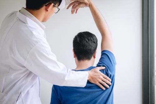 Doctor assisting patient stretch