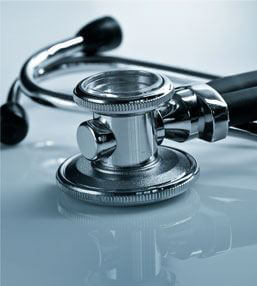 stethoscope lying on a clouded glass table.