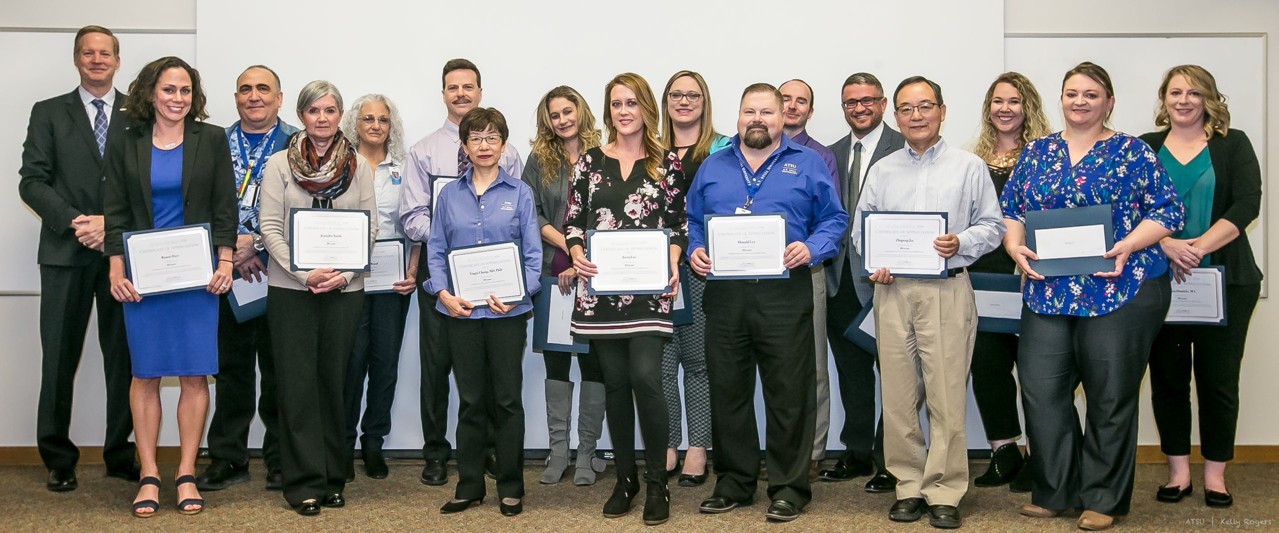 group of staff holding awards