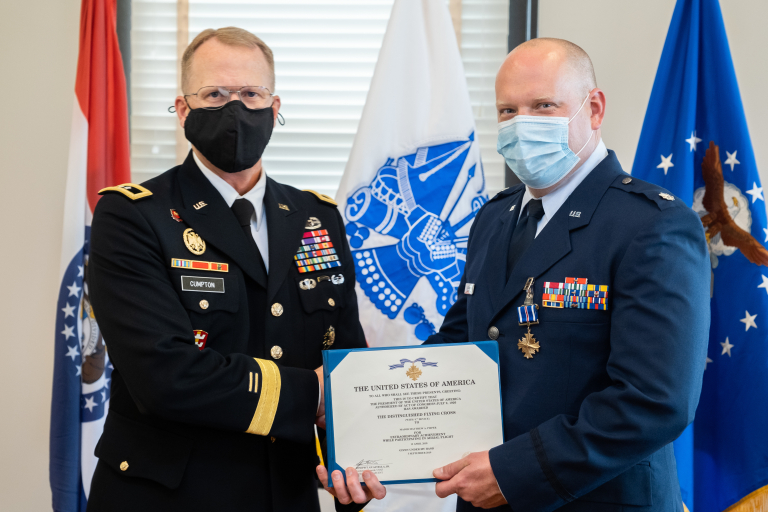 Adjutant General of the Missouri National Guard Maj. Gen. Levon Cumpton presents A.T. Still University-Kirksville College of Osteopathic Medicine alumnus Lt. Col. Matthew Pieper, DO, ’06, a Center for Sustainment of Trauma and Readiness Skills instructor, with the Distinguished Flying Cross during a ceremony at Jefferson Barracks Air National Guard Base, Missouri, Sept. 12, 2021. Dr. Pieper was decorated for his lifesaving actions during a 2018 aeromedical evacuation flight while deployed to Afghanistan.