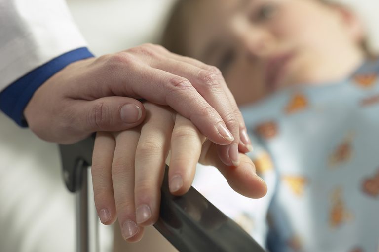 Doctor holding patient hand