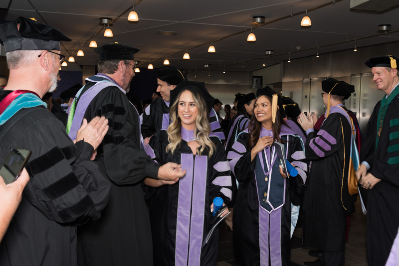 ATSU-ASDOH graduates greet members of ATSU faculty and staff after their commencement ceremony