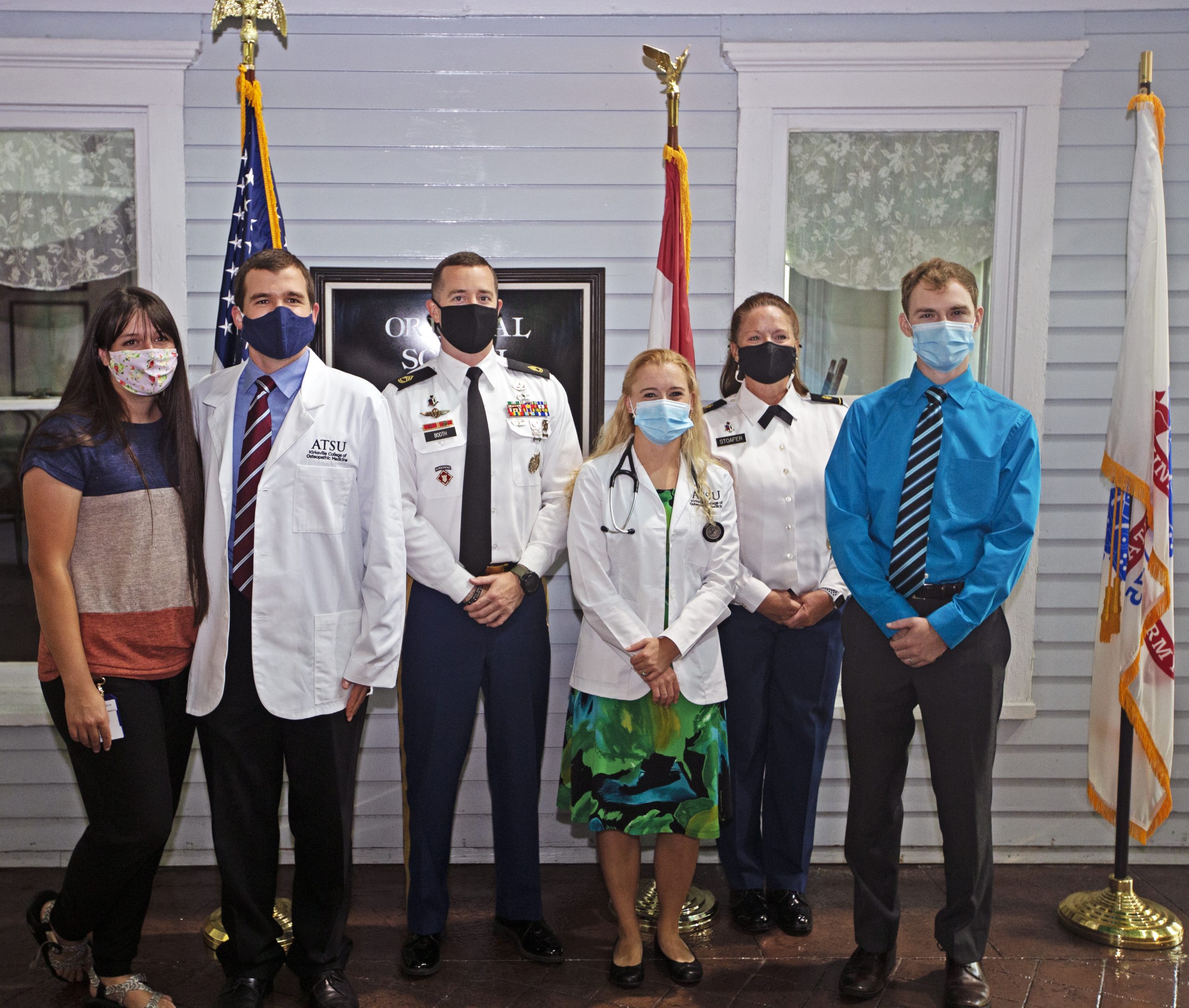 Students and military officers pose for photos.