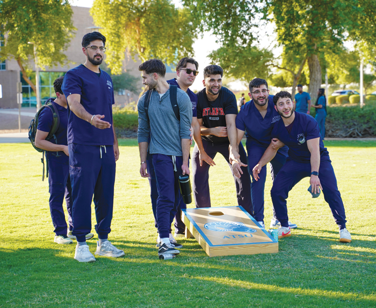 students playing cornhole