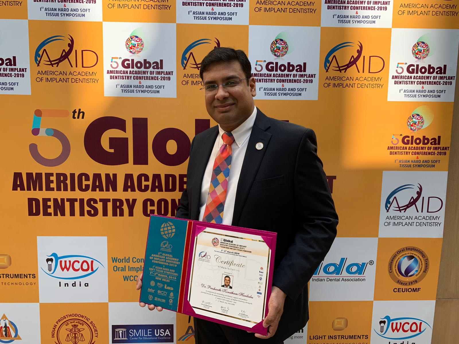 Dr. Haribabu standing with certification award