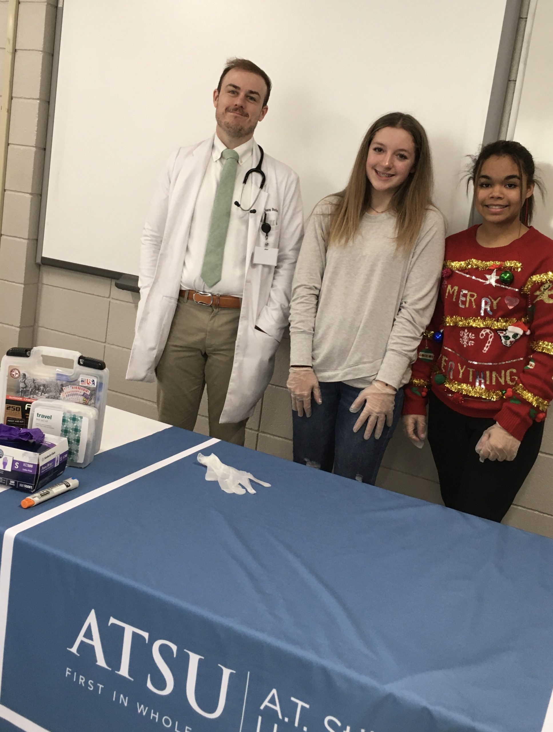 ATSU Kirksville Family Medicine resident Jason Buchan, DO, poses with William Matthew Middle School students Mabry Elmore and Gianna Smith