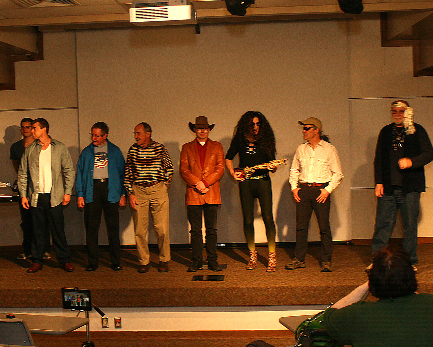 professors standing in costume for air guitar competition