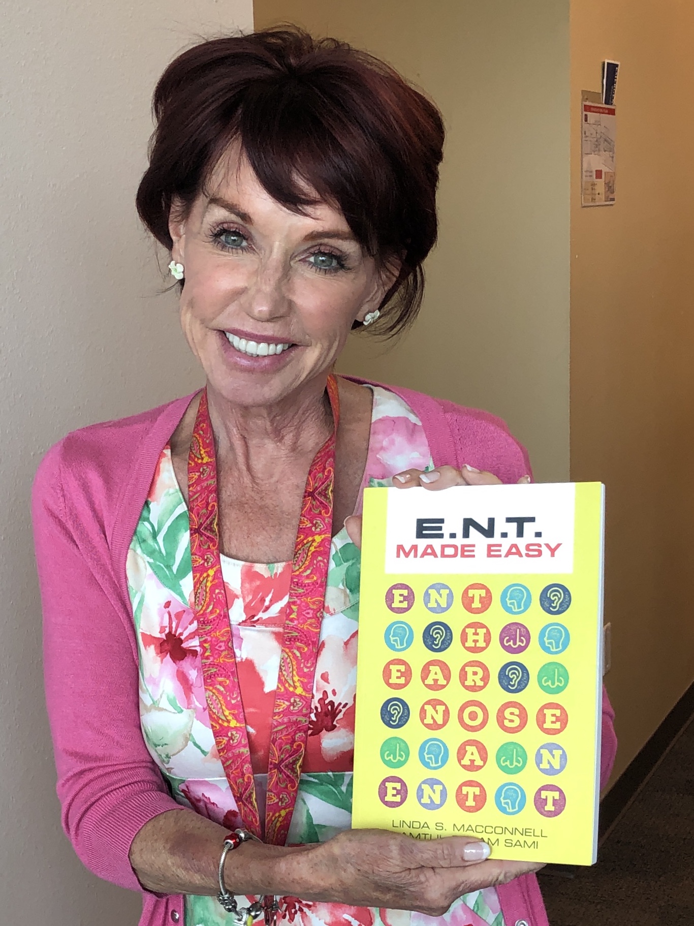 Linda MacConnell holding a copy of ENT Made Easy