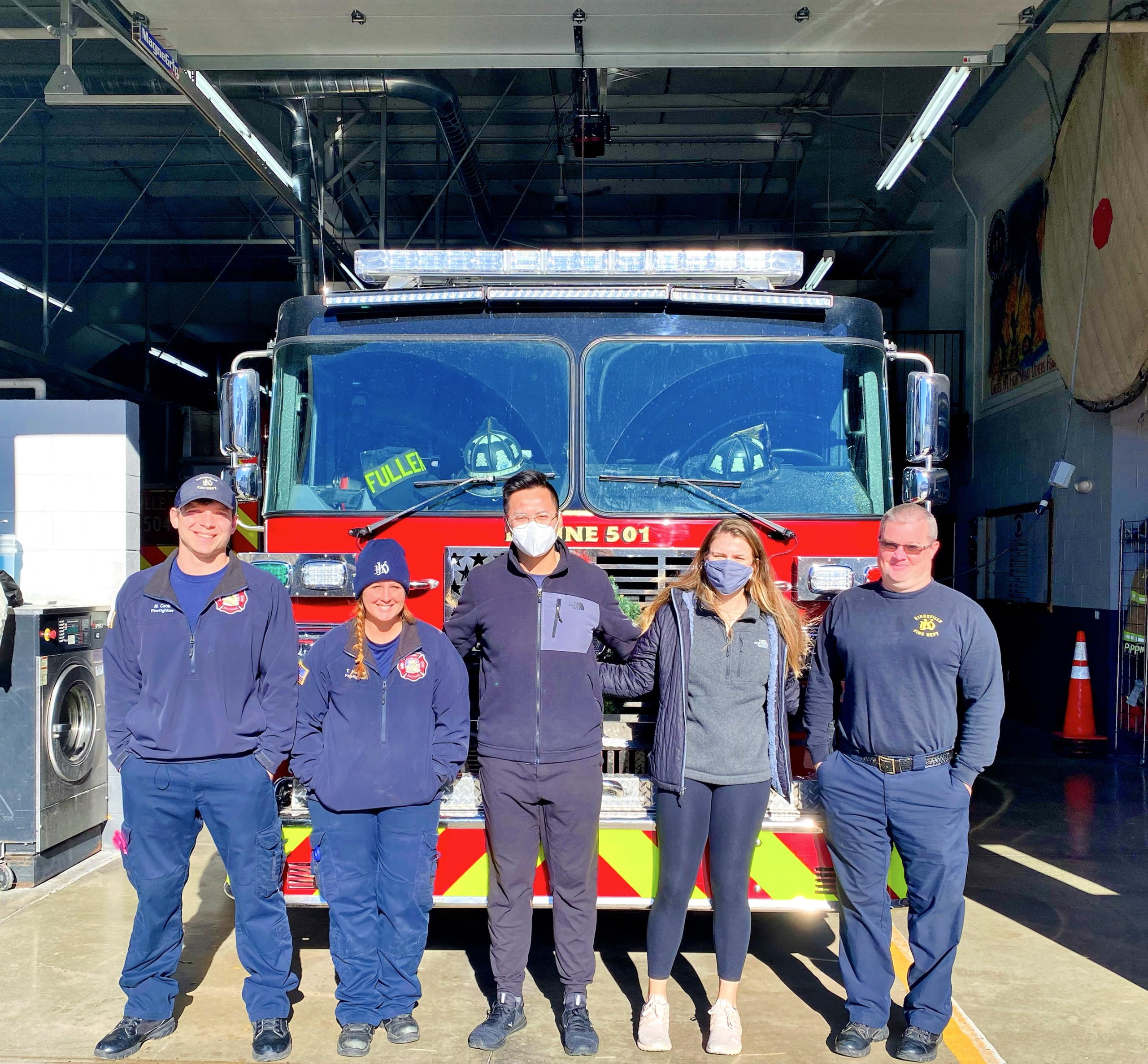Shelby Terrel, OMS II, president of Pediatrics Club, and James LÍu, OMS II, co-president of Alpha Phi Omega, pose with members of the Kirksville Fire Department