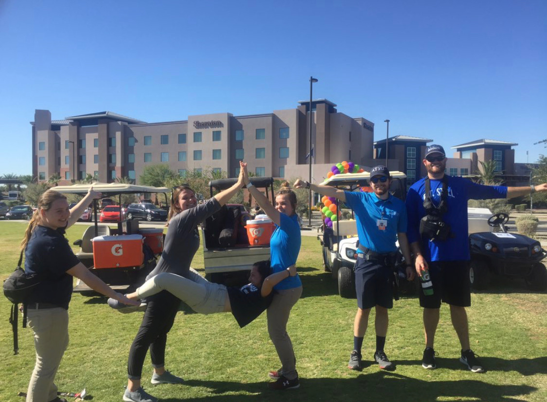 Athletic training students spell out A T with their bodies.