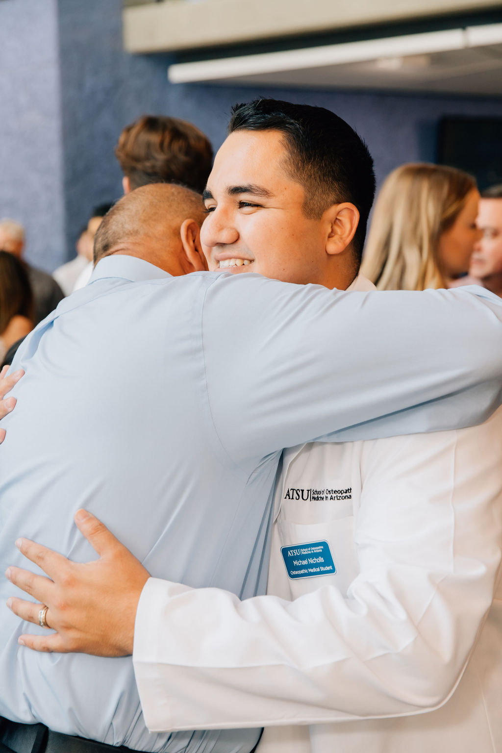 An ATSU-SOMA student embraces someone following the White Coat Ceremony in Mesa, Arizona.