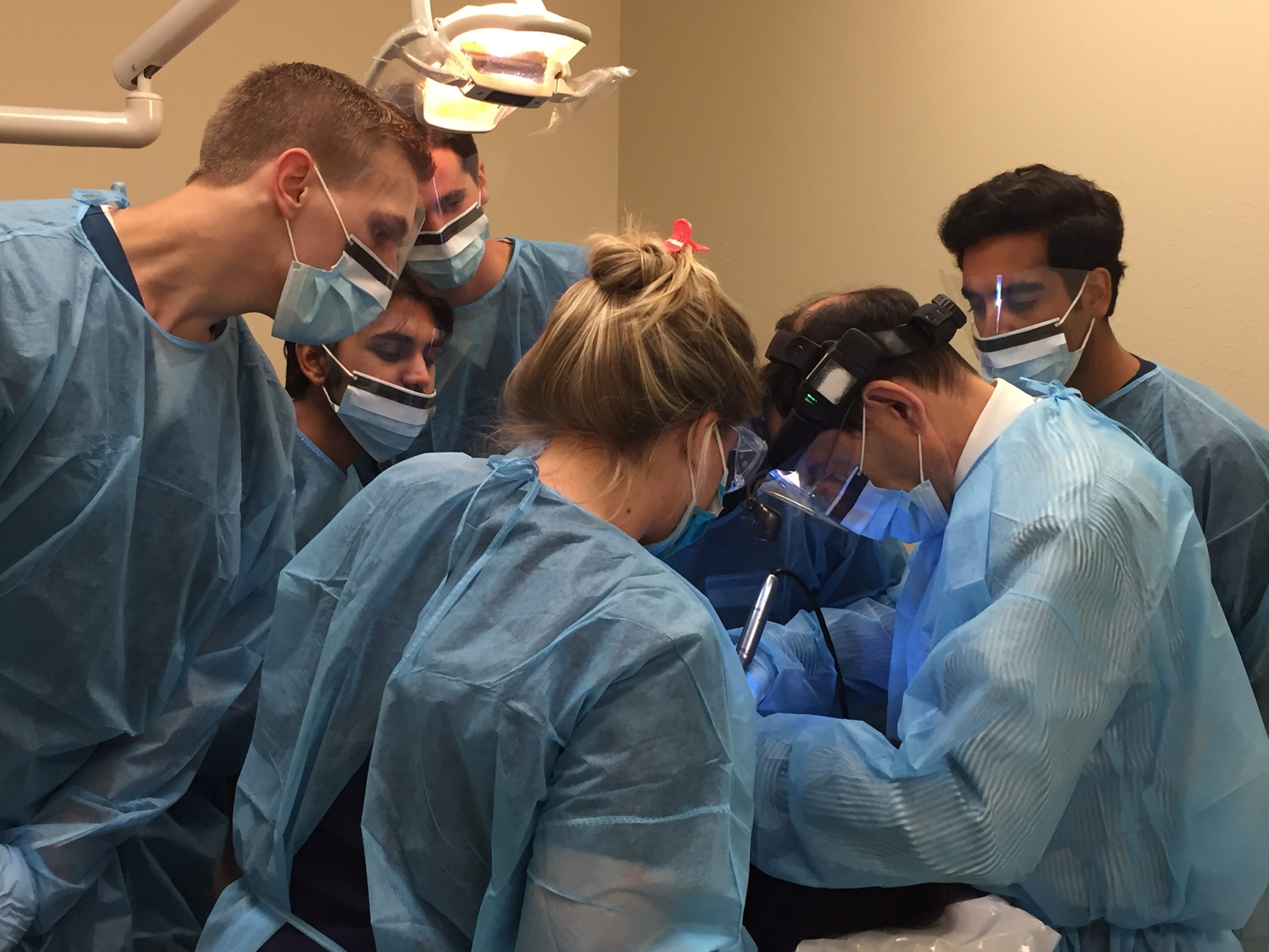 ATSU-SOMA students observe as ATSU-ASDOH students provide dental care.