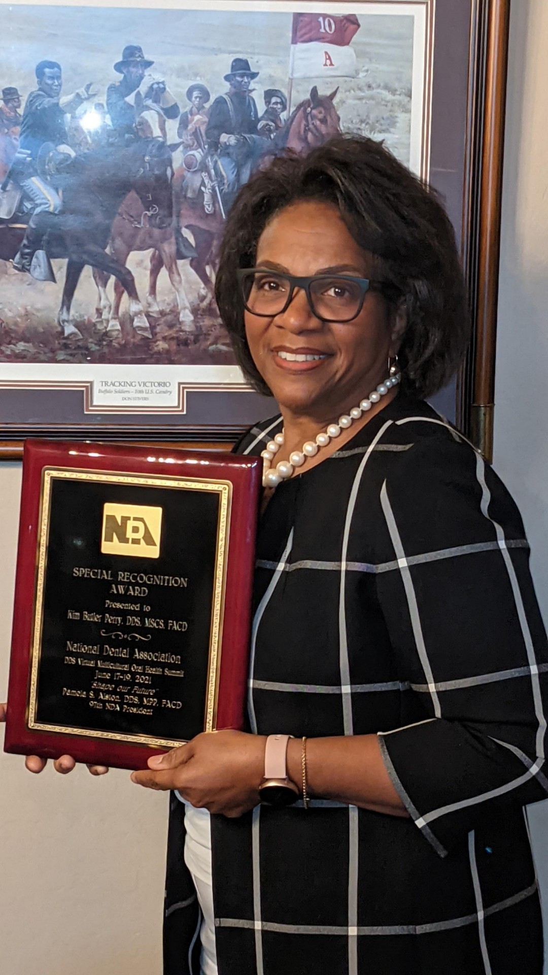 A.T. Still University's Kim Perry poses with an award from the National Dental Association