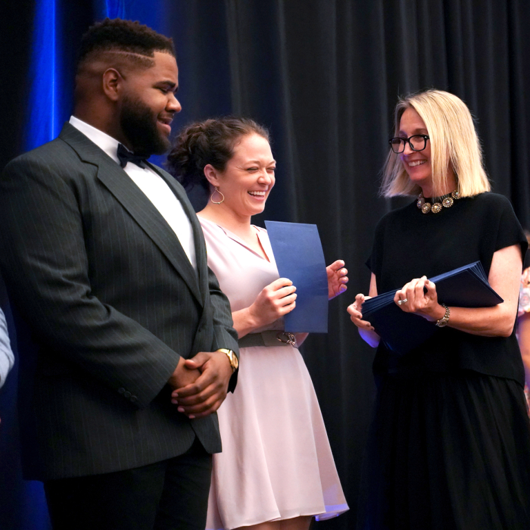 ATSU-SOMA's Sharon Obadia, DO, FNAOME, '97, interim dean, presents awards during a recent event honoring the class of 2022.