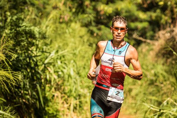 Josiah Middaugh running on trail in Hawaii