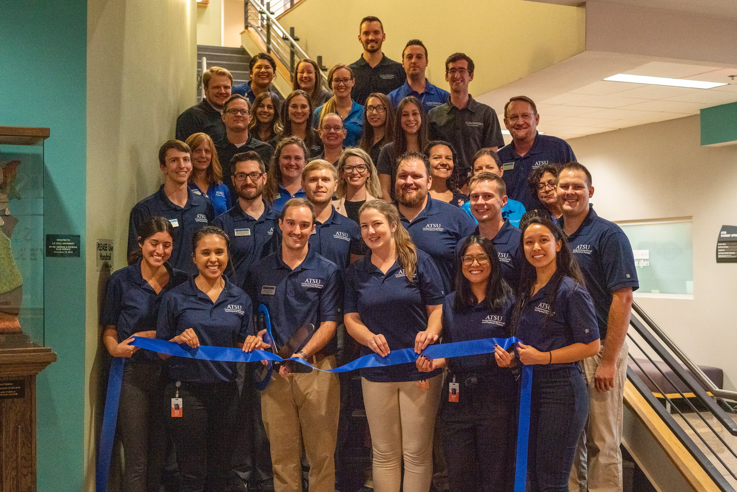 Students and faculty participate in a ribbon cutting for the new OT PT Center at ATSU