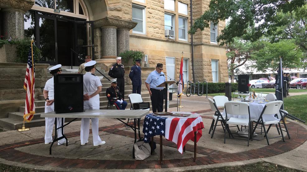 ceremony in front of court house with military members