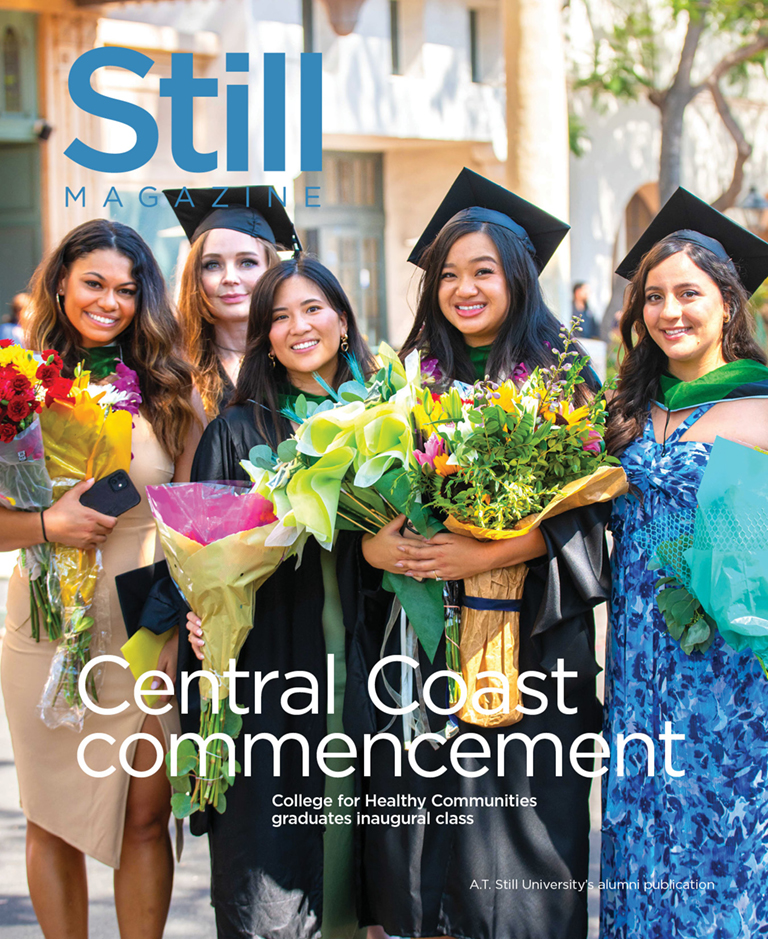 five graduates holding flowers