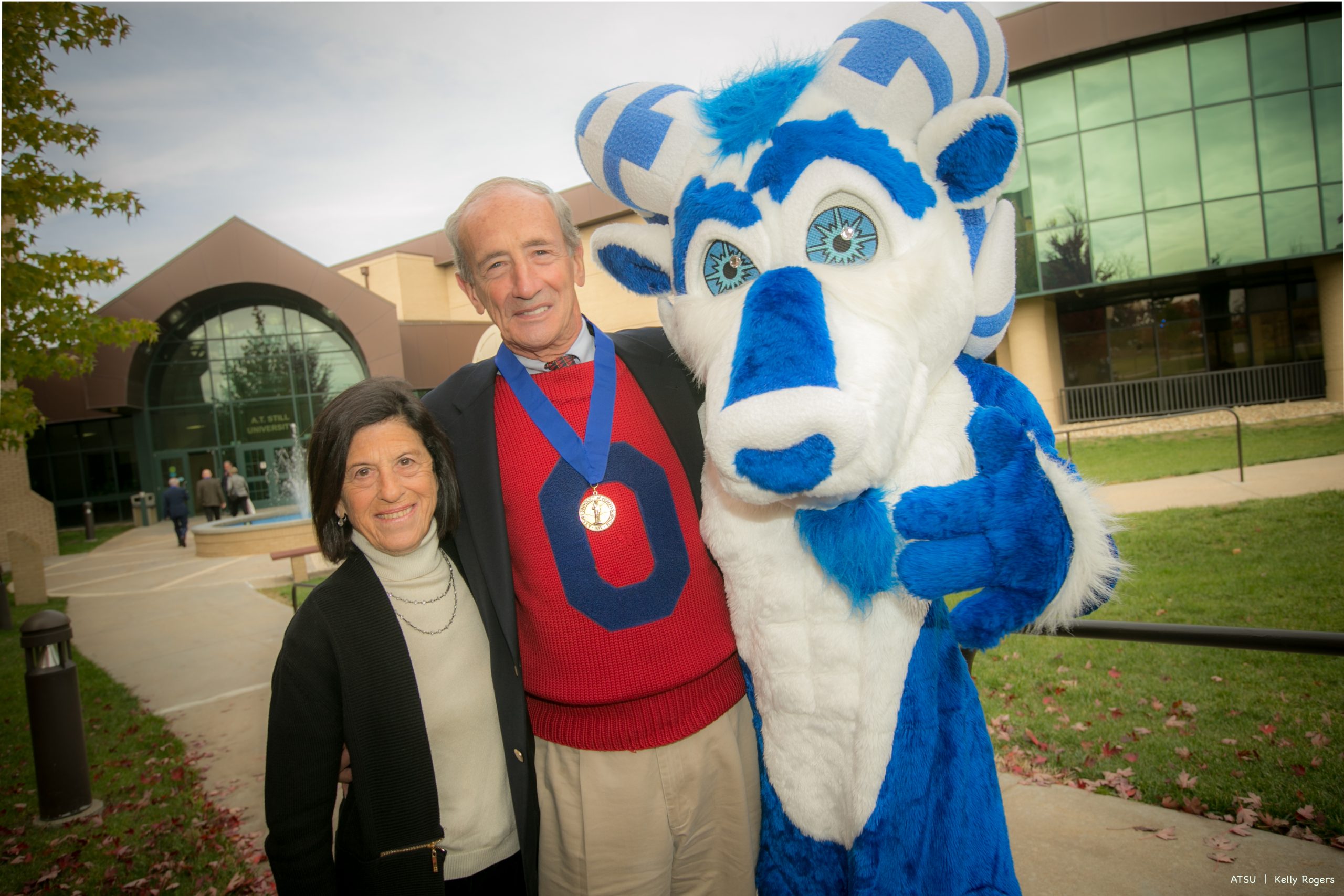 man & woman posing with Bucky mascot