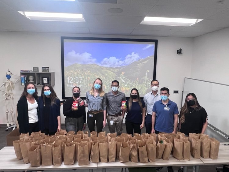 Students pose with brown bag lunches.