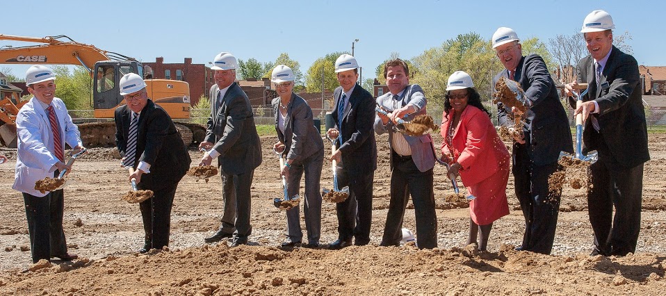 Members of the stage party turn the dirt at the clinic site.