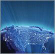 Animated space view of the Earth with light rays illuminating out of the United States.